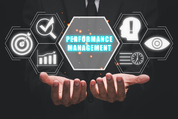 Performance management concept, Businessman hand holding performance management icon on virtual screen.
