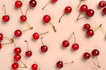 Obraz na płótnie Canvas Red sweet cherries on pink background