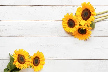 Rolgordijnen Beautiful sunflowers on white wooden background © Pixel-Shot