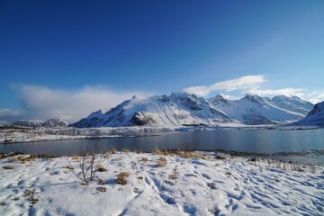 Snow mountain with lake in winter season at Lofoten, Norway, Europe. 