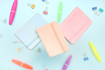 Notebooks with stationery on blue background