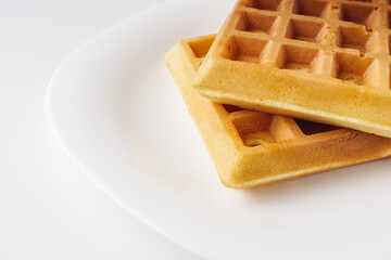 Two delicious Belgian waffles on white background