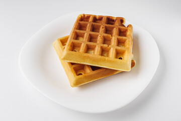 Two delicious Belgian waffles on white background