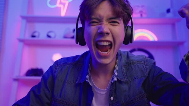 Asian attractive Esport male gamer play online video game on computer. 