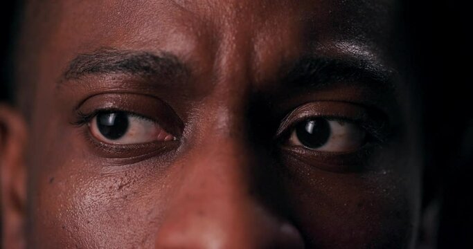 A Haunting Close-up Shot Of An African American Man's Terrified Eyes Sends Chills Down The Spine, Conveying The Raw Fear And Vulnerability Of The Human Experience.