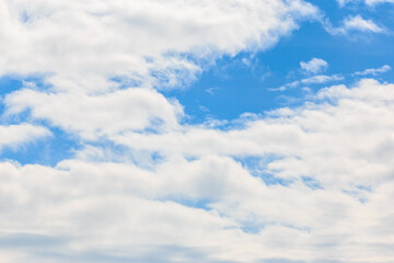Naklejka na ściany i meble A sunny day with blue skies and white clouds