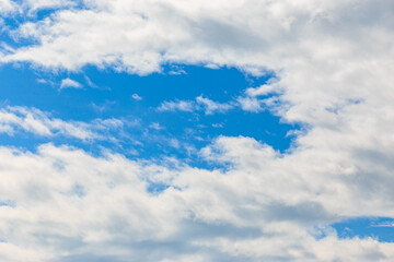 Naklejka na ściany i meble A sunny day with blue skies and white clouds