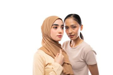 women with hijab and no hijab wearing cream t-shirt posing in white background