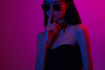 Fashion and beauty concept, Fashion woman with glitter makeup wear sunglasses on neon background