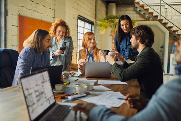 Young group of designers having a meeting in the office