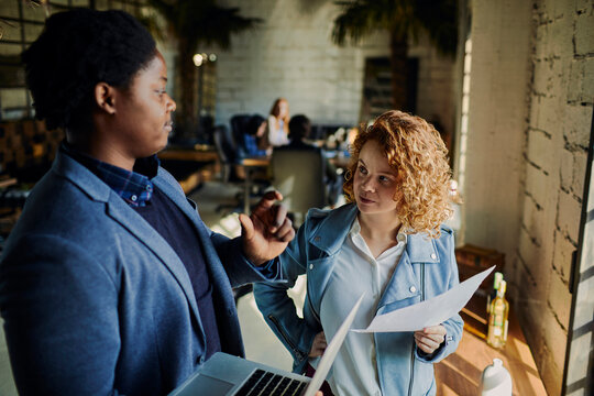 Young man and woman working together in a startup office