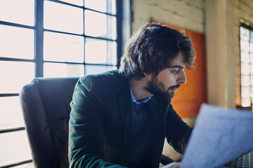 Young man working in an office for a startup company