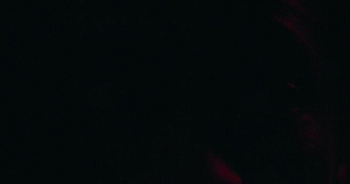 African American victim of police brutality excessive force his intense gaze could convey pain fear anger at unjust treatment received flashing lights over background suggest police justify actions.