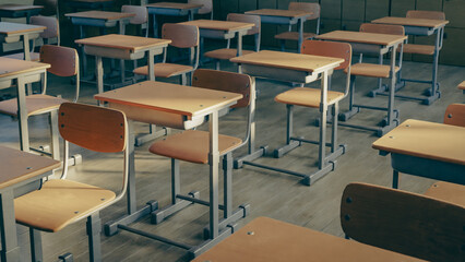 Empty school classroom desks and chairs, 3d rendering