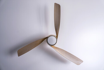 Modern wood ceiling fan isolated in center of white background