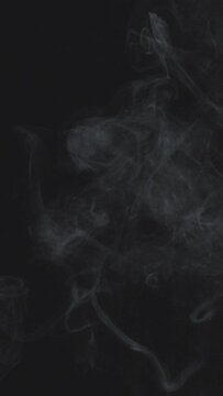 Slow Motion Vertical Video Of White Smoke, Fog, Mist, Vapor On A Black Background.