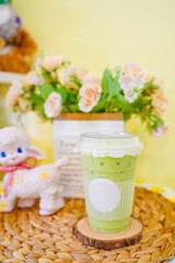 Obraz na płótnie Canvas A cup of Thai green tea milk tea on the table