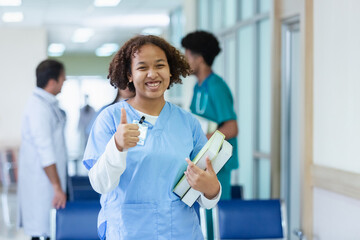 Portrait of woman medical student thumbs up holding school book have group students on background...