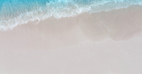 Fototapeta na wymiar Wave water in the Tropical summer beach with white sand beach background