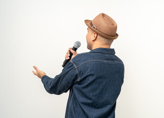 Happiness young asian man singing song. Artist vocalist singer on isolated background. Confident man public speaking talking with microphone in studio.