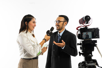 a beautiful journalist interviewing an adult men with eye glasses using a black microphone and recorded by one set of camera