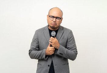 Businessman speaker with high quality dynamic microphone speaking talking with people on isolated white background. Male testing microphone voice for interview. Motivation life coach in training