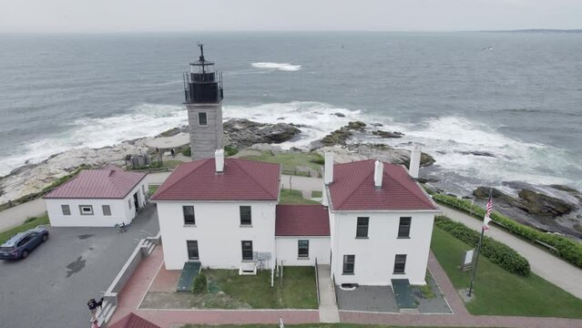Aerial pass of Beavertail Lighthouse in Jamestown, RI looking over the Atlantic Ocean.