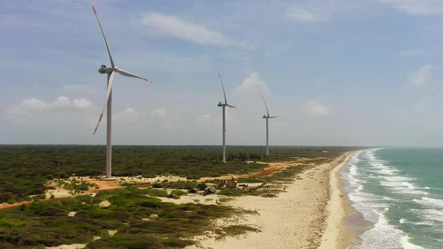 Aerial drone of Wind Turbine Power Generators At Sea Coastline. Alternative Renewable Energy. Mannar, Sri Lanka.