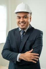 Vertical of Businessman manager owner real estate at modern office building. Cooperation of architect designer. Engineer with safety helmet checking at working construction site