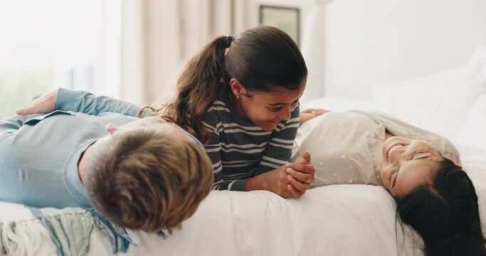 Parents, bed and child playing in a bedroom with mother and father as bonding with happiness together as a family. Happy, funny and kid with love or care for mom and dad in the morning at home