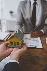 Real estate agents and insurance salesmen for home and land purchases are handing over homes to clients after agreeing and signing contracts in the office.