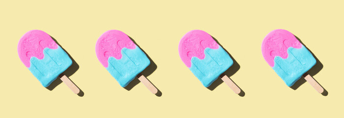 Pink and blue popsicles with shadow - flat lay