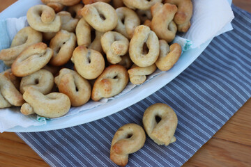 Homemade traditional italian snack from Puglia called Taralli on a white bowl on wooden table