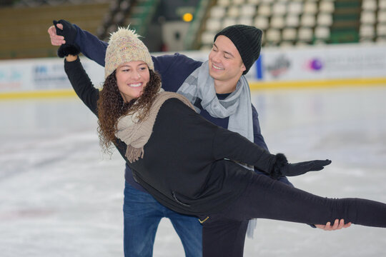 a young couple ice skating