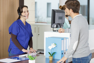 man and woman are talking on gym reception