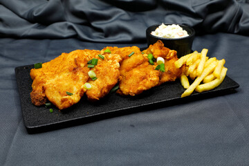 Fish and chips is a hot dish consisting of fried fish in batter, served with chips.