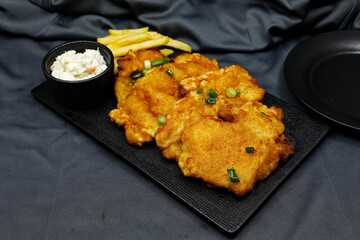 Fish and chips is a hot dish consisting of fried fish in batter, served with chips.