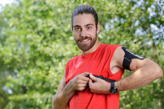 man putting chest strap for exercise