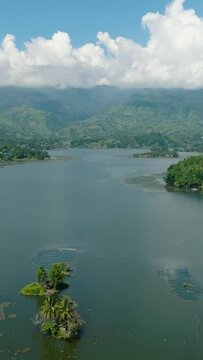 Drone survey of Lake Sebu surrounded by dry land, mountain forest. Mindanao, Philippines. Eco-Tourism destinations. Vertical view.