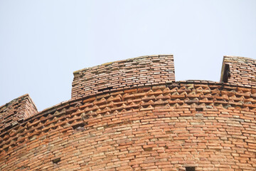 Fragments of the old fortress. From red brick. Fortress loopholes.