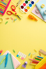 Discover the joy of education for small kids through this top view vertical image: a captivating arrangement of vibrant school supplies on a sunny yellow surface, with space for text or promotions