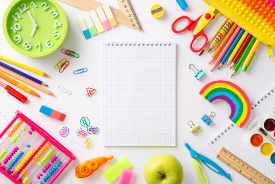 Embark on a captivating learning journey with this creative top-down image: a vivid collection of child school essentials set against a white backdrop, offering copyspace for text or advertising