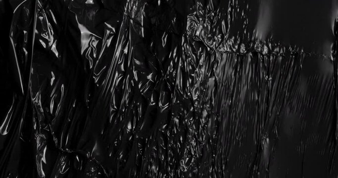 Embark on visual journey fascinating texture stretched plastic film on dark backdrop capturing organic tactile essence reminiscent of rumpled cellophane wrap frequently used for food packaging.