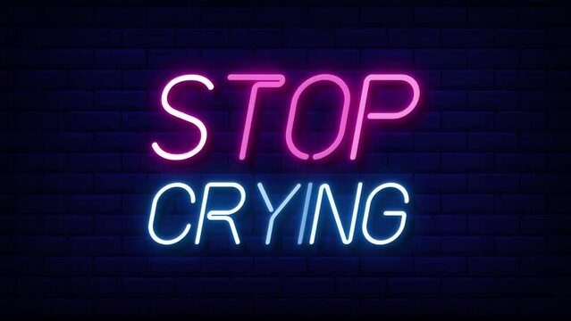 stop crying neon light text on brick wall background motion animation. Glowing large text concept looping animation.