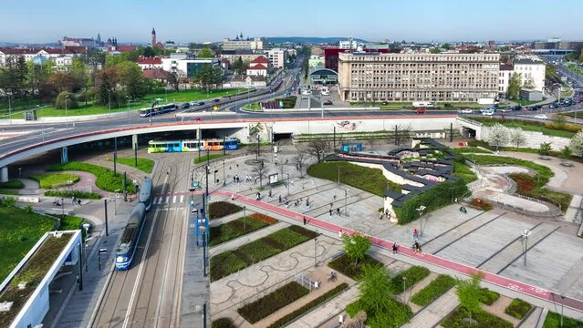 Rondo Mogilskie roundabout in Krakow, Poland. Multilevel  extended crossroad of streets and tramways with cars, trams, tram stops, bike lanes, pedestrian crossings, park and old walls. Aerial video