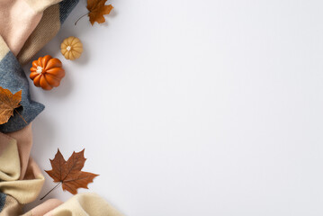 Enjoy the cozy autumn vibes at home: Top view photo featuring warming cashmere plaid, maple foliage...