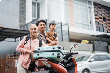 Obraz na płótnie Canvas beautiful muslim family going with motorbike together during eid mubarak holiday