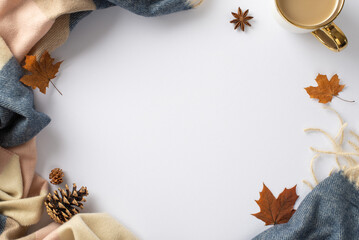 Experience the feeling of warming up in fall season with warm patchy plaid and a mug of hot cocoa drink and maple leaves around on this high angle photo on white isolated background with empty circle