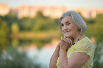 A beautiful elderly walks near their house 