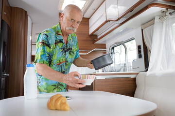 senior man in his camping van